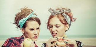 junk food vs healthy food: ywo girls making difference between foods